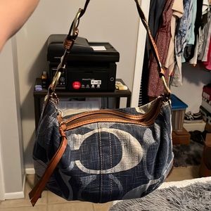 Coach denim purse with a braided leather strap